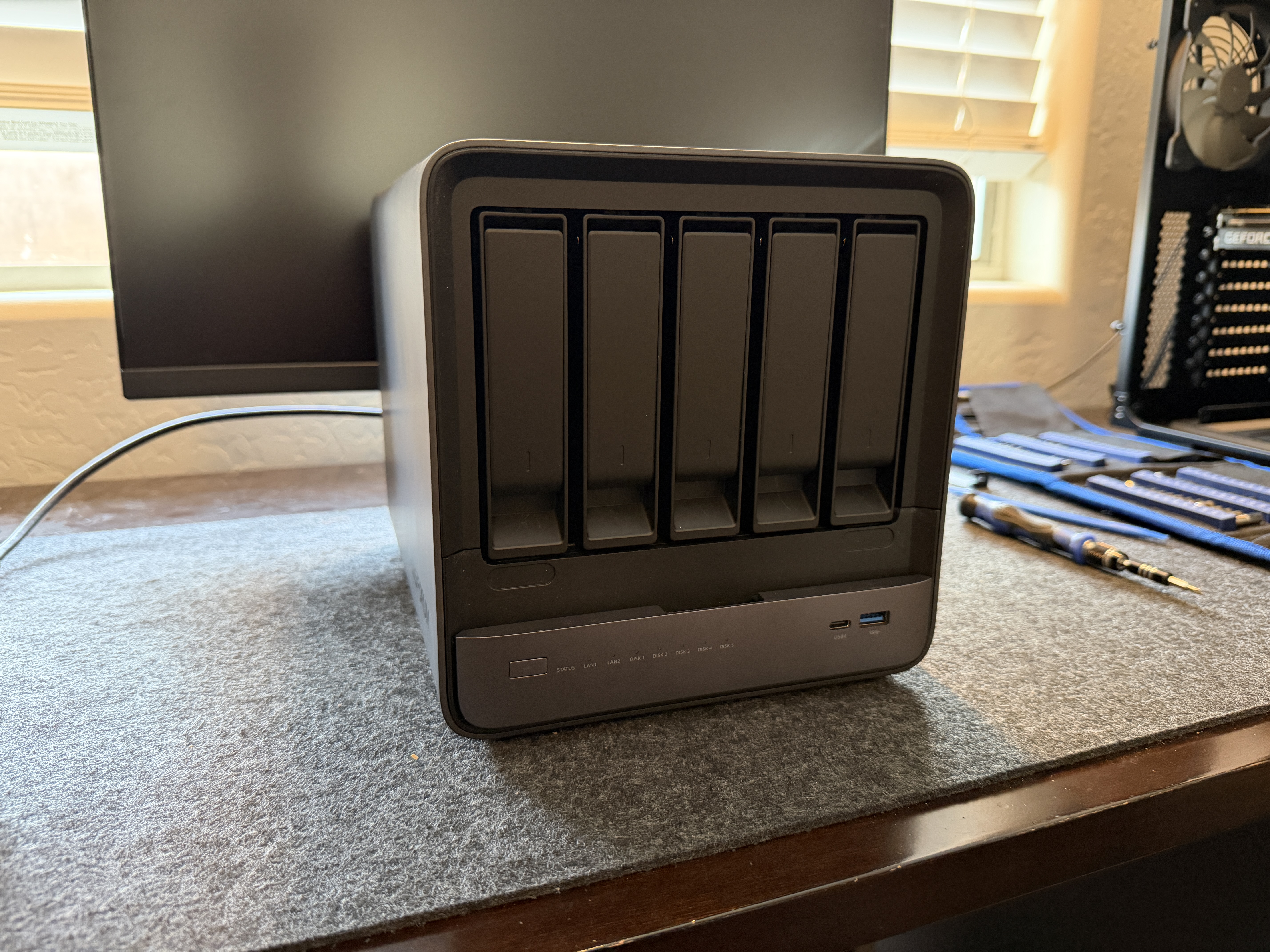 Minisforum N5 Air three-quarter front view showing matte plastic finish and branding