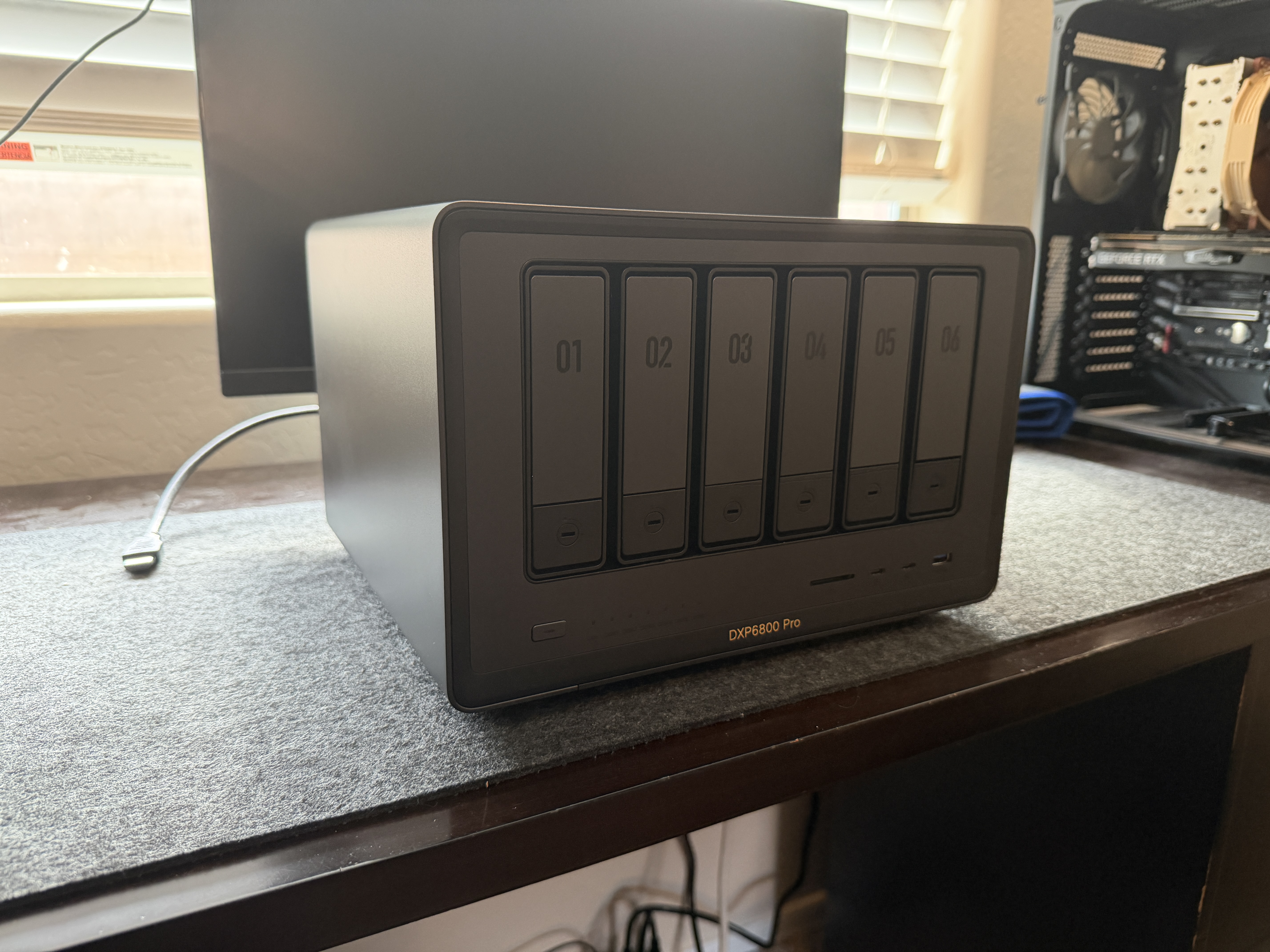 UGREEN DXP6800 Pro front three-quarter view showing 6 drive bays and metal chassis